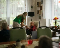 senior woman caregiver talking living room