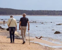 elderly walking on the beach