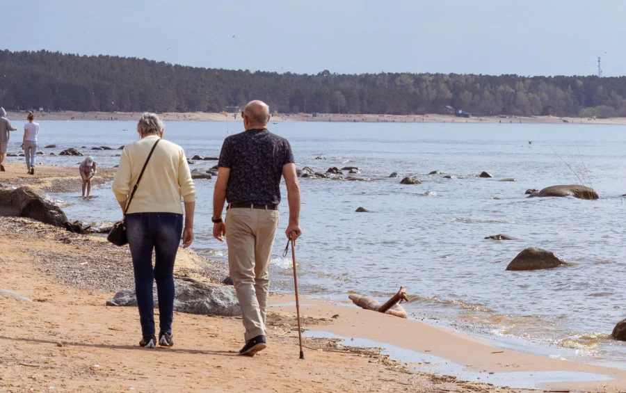 elderly walking on the beach