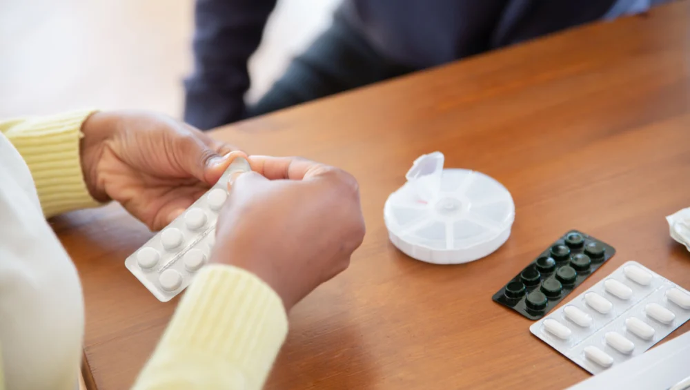 woman handling medicine at the table